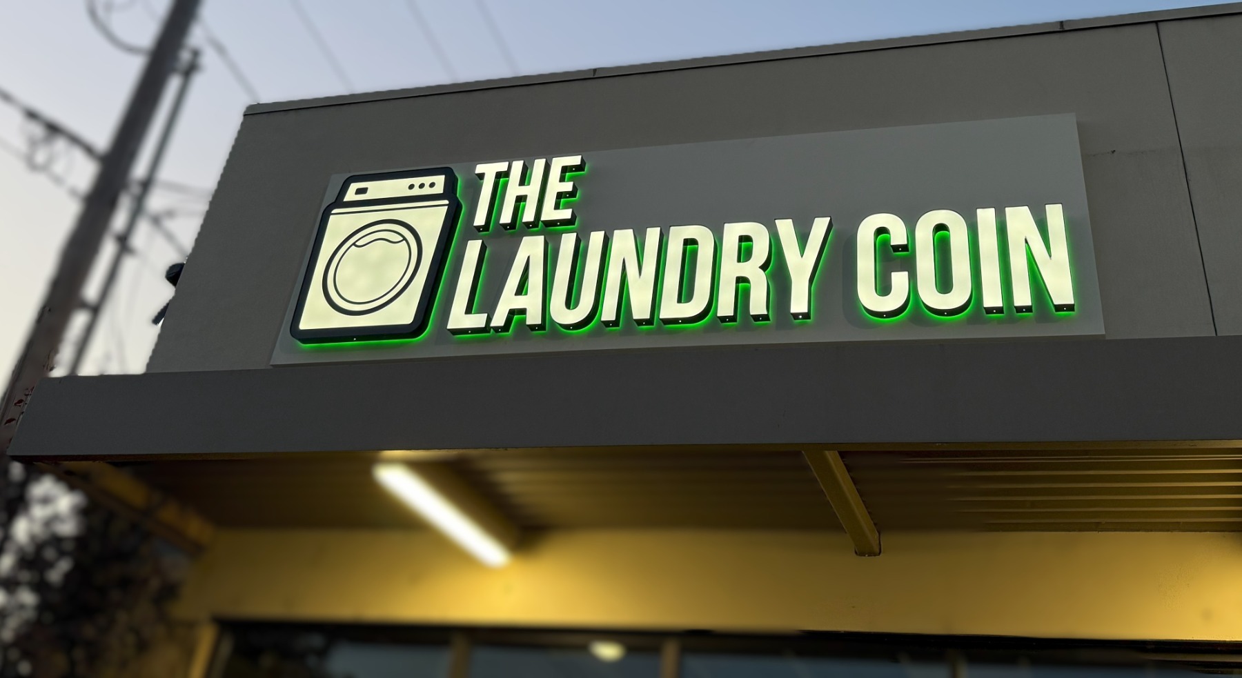 Stacked washer-dryers beside the Value Add Center kiosk